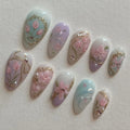 Handmade pastel pink and lilac floral press-on nails with gold frame and bow details