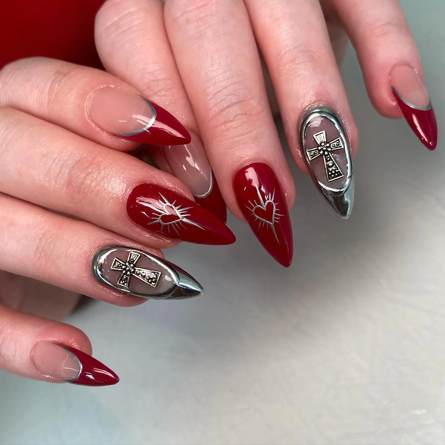 Handmade red and silver press-on nails with cross and heart gothic French art designs.
