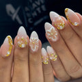 Handmade white floral press-on nails with gold 3D pearl accents, elegant wedding design
