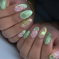 Handmade sage green press-on nails with butterfly and floral 3D designs.