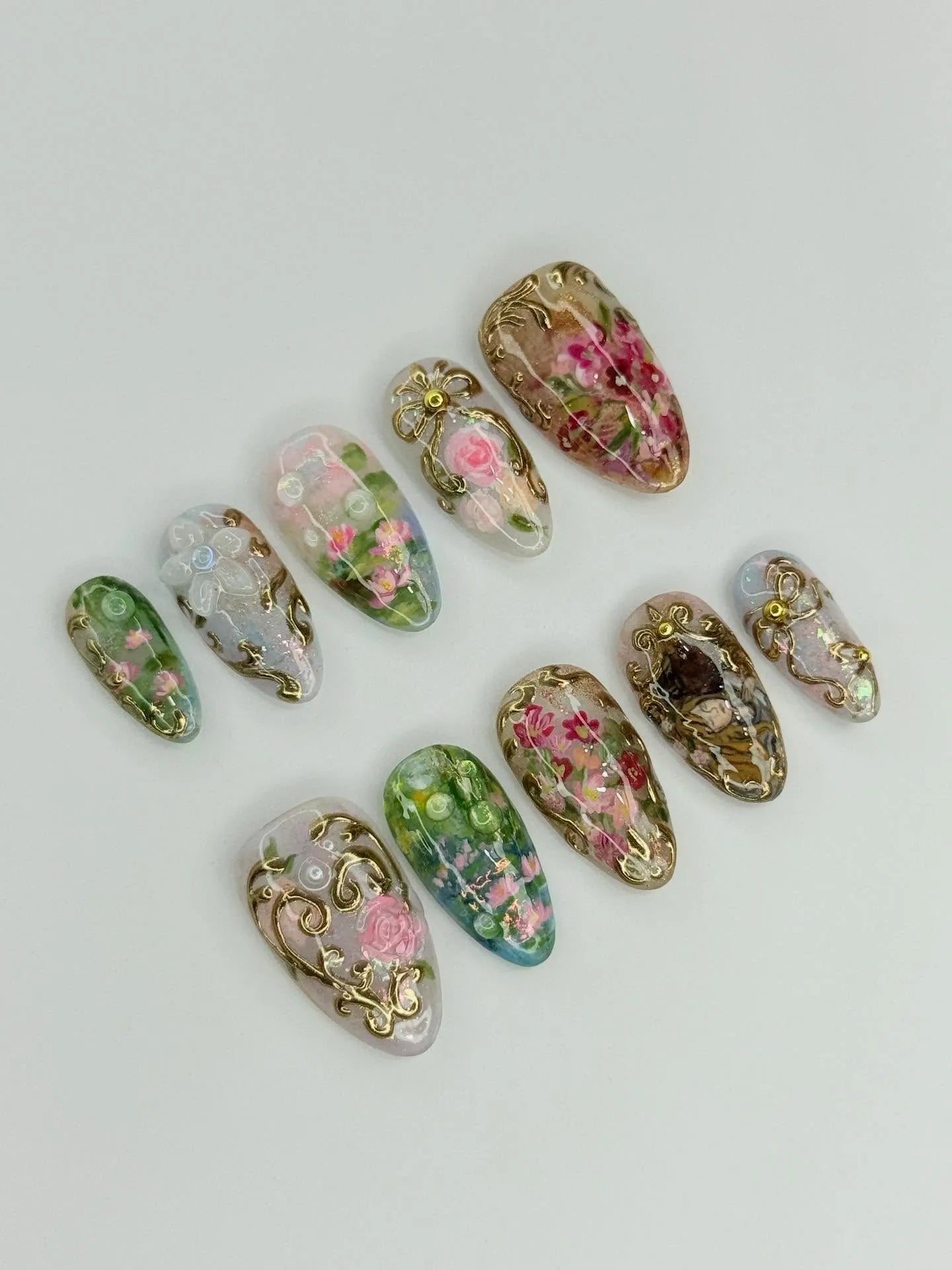 Handmade press-on nails with pink roses, gold filigree, floral and garden-inspired designs.