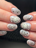 Handmade oval press-on nails with celestial bunny, stars, chrome ribbon, and shimmer accents