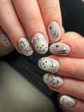 Handmade shimmering celestial bunny press-on nails with chrome ribbon, stars, and floral accents.