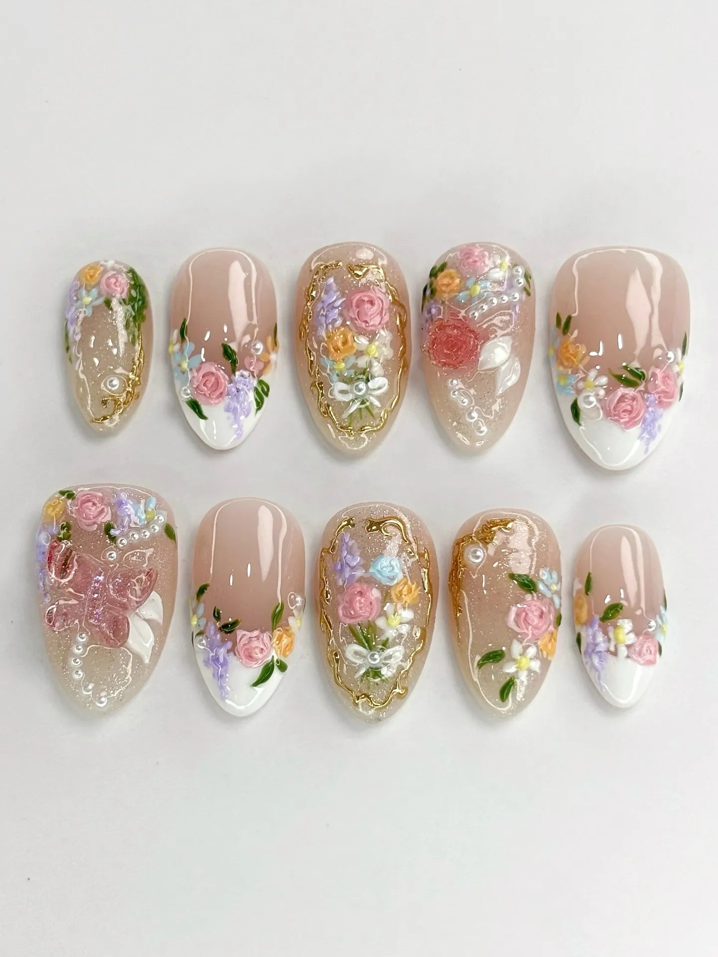 Handmade shimmering press-on nails with 3D rose floral designs, pearls, and gold filigree accents.