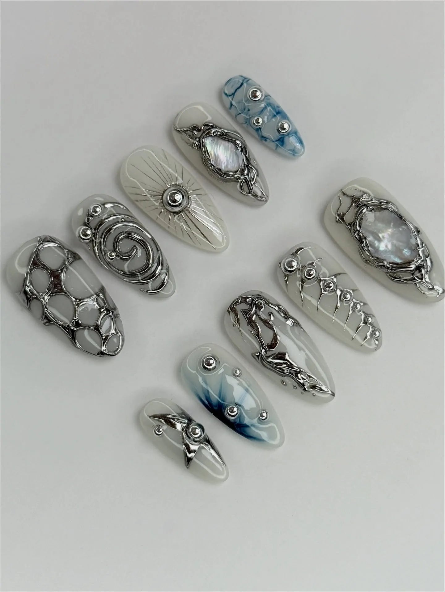 Handmade silver metallic cyber shell liquid chrome press-on nails with unique 3D designs