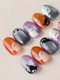 Handmade Halloween press-on nails with ghost and black cat designs on orange, purple and gray shimmer backgrounds.