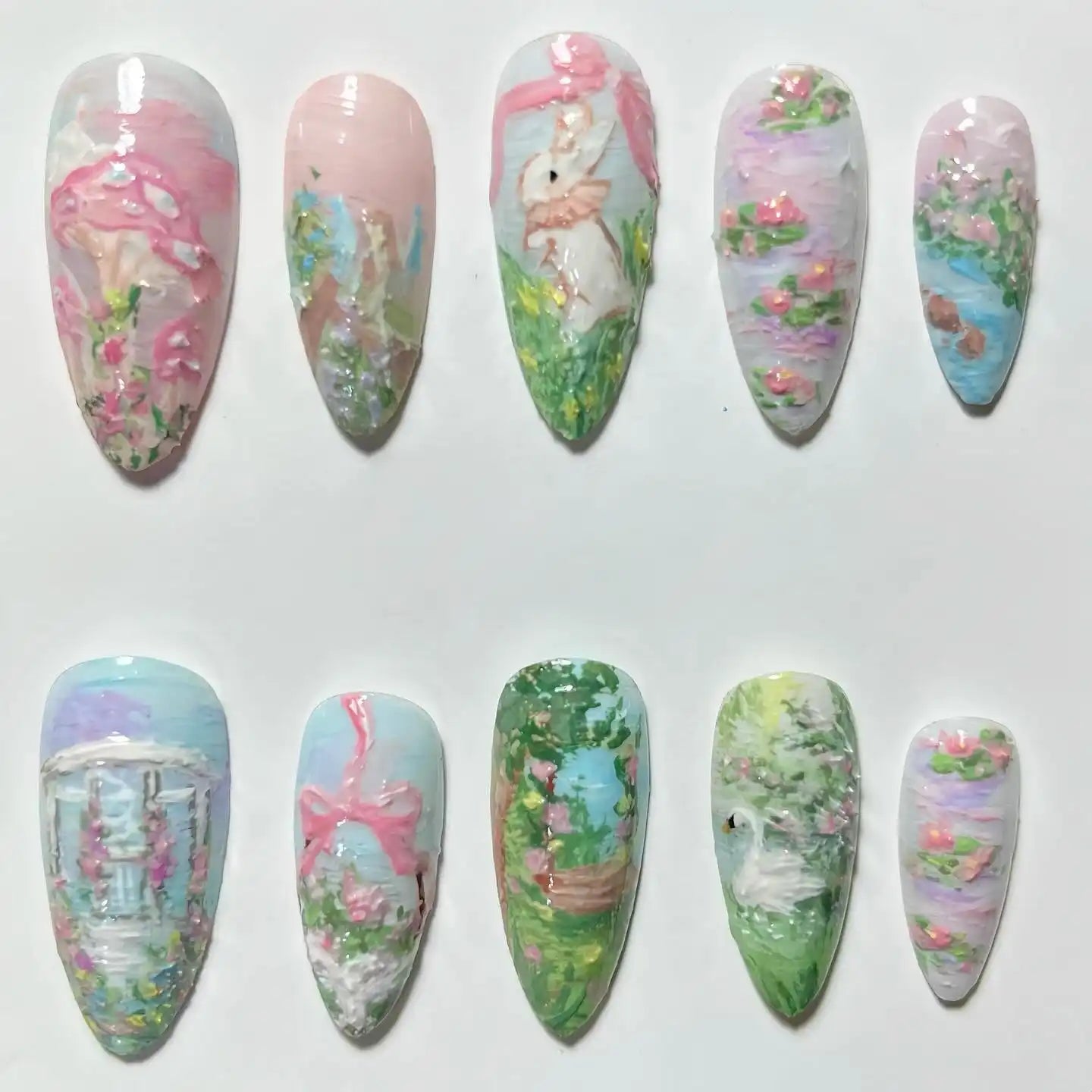 Handmade press-on nails with spring garden, bunny, pastel flowers, and romantic landscape art.