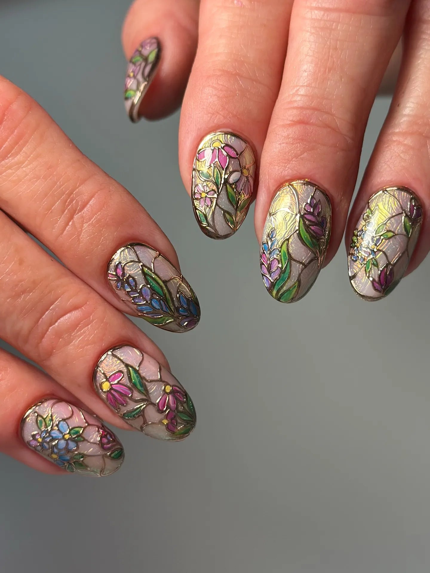 Handmade press-on nails with stained glass floral design, multicolored flowers and gold outlines
