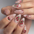 Handmade press-on nails with strawberry art, white lace French tips, and pearl accents.