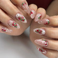 Handmade press-on nails with strawberry art, lace details, and pearl accents on almond tips