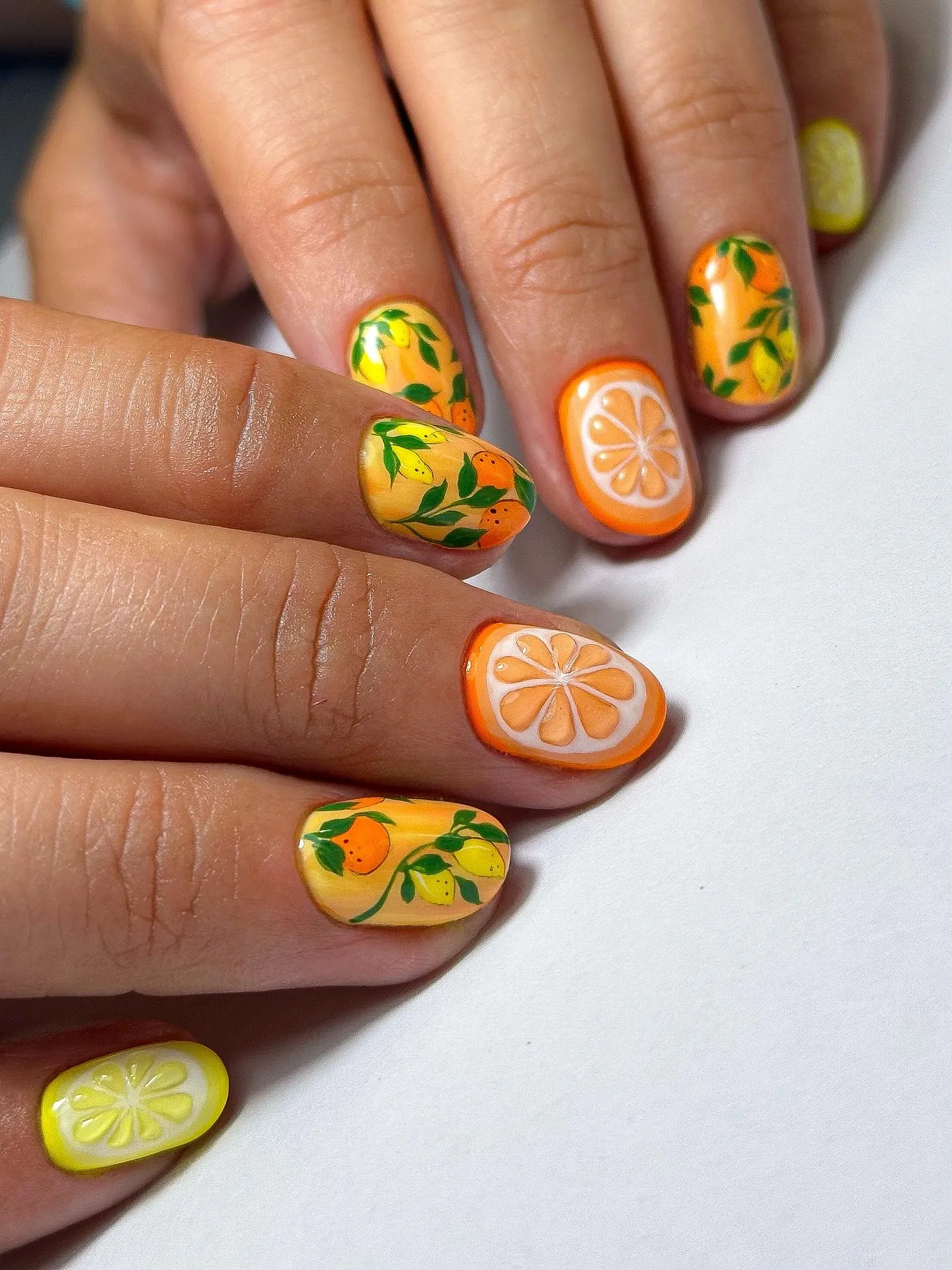 Handmade press-on nails with citrus lemon and orange fruit designs, garden summer nail art.