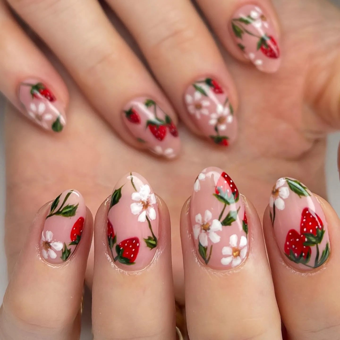 Handmade pink press-on nails with strawberry and white floral summer designs
