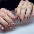 Handmade press-on nails with pink base, strawberry and white floral summer design