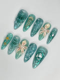 Handmade teal shimmer 3D press-on nails with jellyfish, starfish, and shell ocean designs