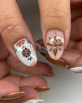 Handmade terracotta floral press-on nails with lace accents and gold embellishments