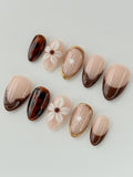Handmade press-on nails with tortoise shell, 3D floral, and brown French tip designs