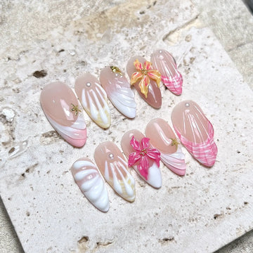 Handmade tropical press-on nails with 3D shell and hibiscus flower designs in pink and white.