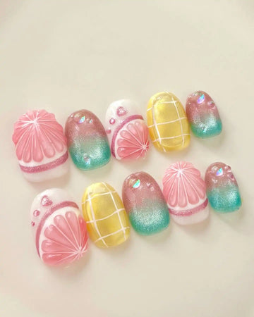 Handmade press-on nails with tropical fruit gradient, yellow grid, and shimmering summer design