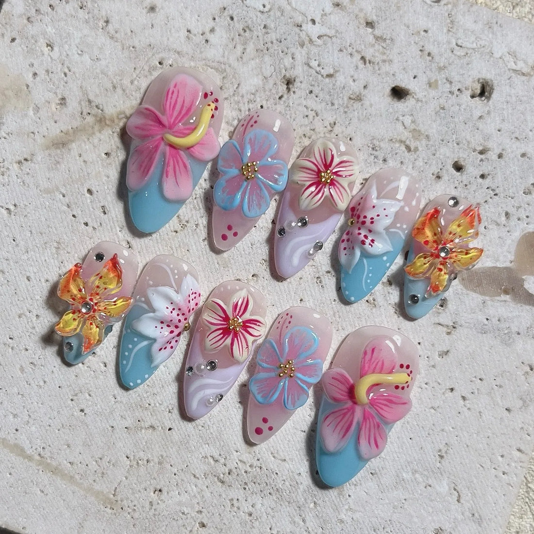 Handmade press-on nails with 3D tropical hibiscus floral designs in bright summer colors.
