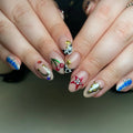 Handmade Western cowgirl press-on nails with cow print, cherries, horseshoes, stars, and 3D accents.