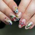 Handmade press-on nails with cow print, cherries, horseshoe, western stars, and skull designs